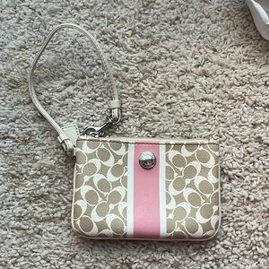 Coach wristlet in excellent condition! One scratch in the middle pink leather.